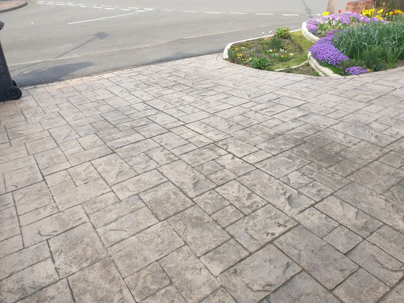 Printed concrete driveway before being cleaned and re-sealed in Ilkeston: Swipe To View More Images