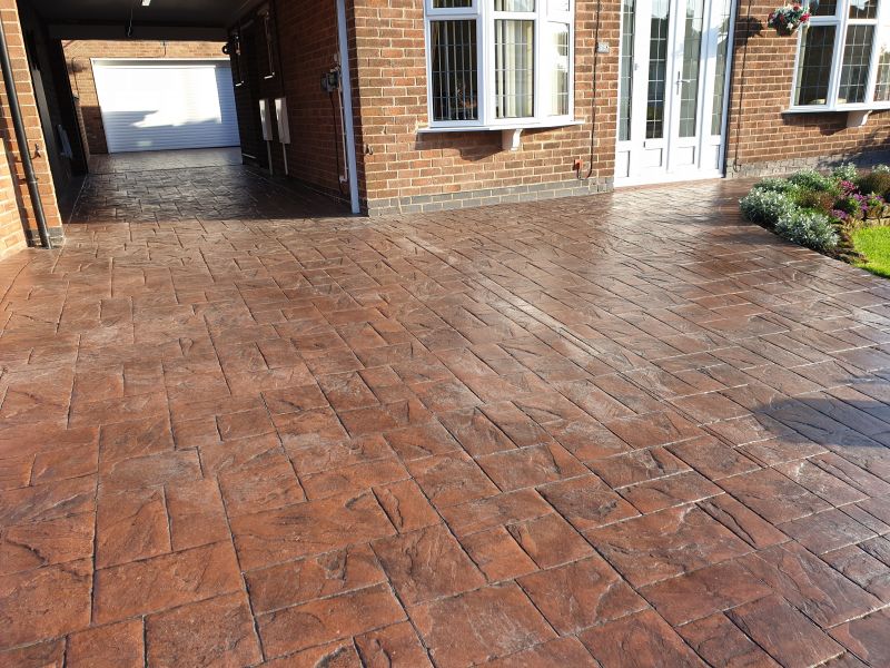 Printed concrete driveway before being cleaned and re-sealed in Ilkeston: Swipe To View More Images