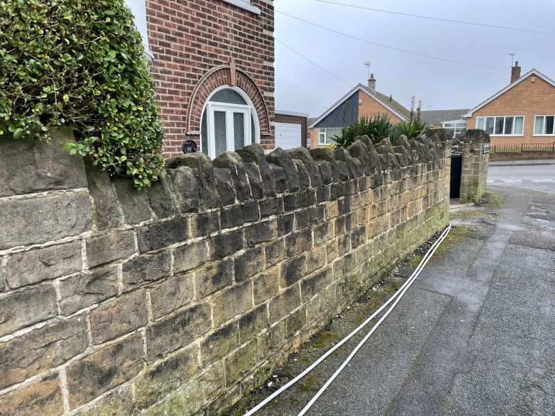 Stone wall in Langley mill,Derbyshire before being cleaned : Swipe To View More Images